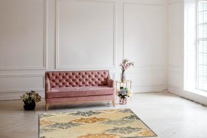 Luxury rich living room interior design with elegant classic furniture and wall decorations. Large light white room with big window