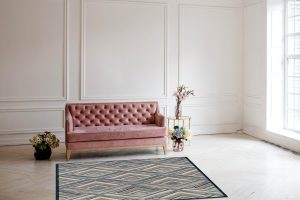 Luxury rich living room interior design with elegant classic furniture and wall decorations. Large light white room with big window